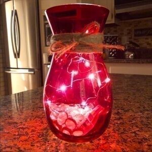 Red vase with string fairy lights